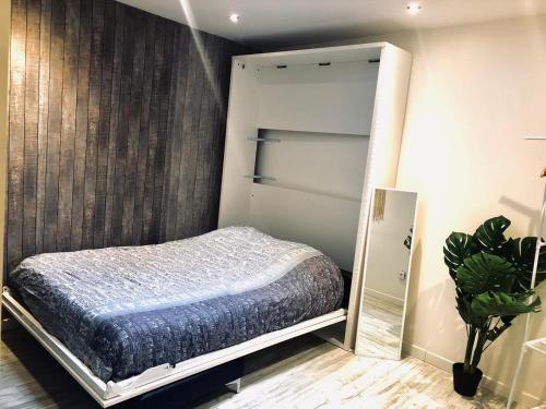 a bedroom with a bed and a closet at Studio avec toit terrasse privé, en centre ville - 004 in Rouen