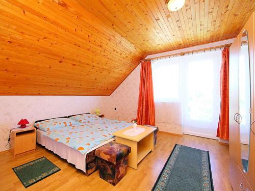 a bedroom with a bed and a large window at Holiday home in Balatonlelle 40449 in Balatonlelle