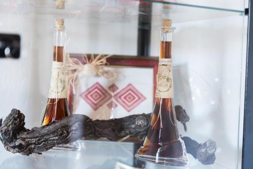 two bottles of wine sitting on a glass shelf at B&B Villa Dubrovnik Garden in Dubrovnik