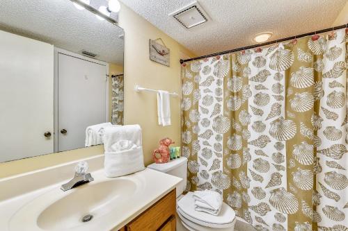 a bathroom with a sink and a toilet and a shower at Commodore Resort #703 by Book That Condo in Panama City Beach