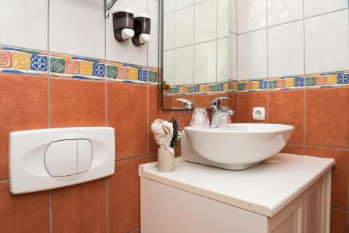 a bathroom with a sink and a mirror at B&B Villa Dubrovnik Garden in Dubrovnik