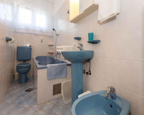 a bathroom with a blue sink and a toilet at Apartment in Vrbnik/Insel Krk 36851 in Vrbnik