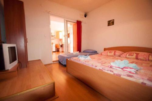 a bedroom with two beds and a flat screen tv at Studio in Vrbnik/Insel Krk 36786 in Vrbnik