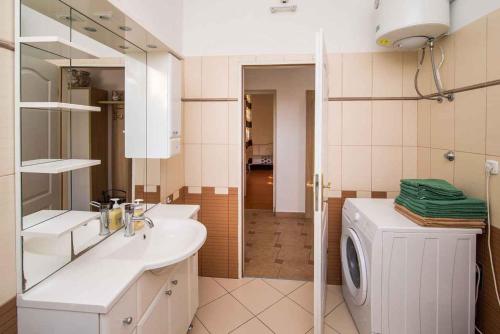 a bathroom with a sink and a washing machine at Apartment in Vrbnik/Insel Krk 36842 in Vrbnik