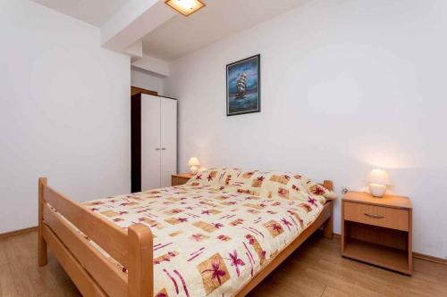 a small bedroom with a bed and two night stands at Apartment in Vrbnik/Insel Krk 36856 in Vrbnik