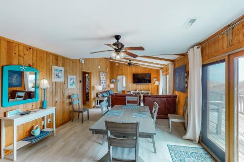 a dining room with a table and a couch at Hunter Haven #6HHH in Hatteras