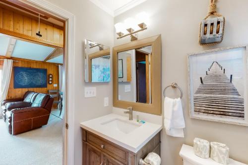 a bathroom with a sink and a mirror at Hunter Haven #6HHH in Hatteras