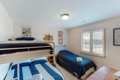 a bedroom with two bunk beds and a window at Hunter Haven #6HHH in Hatteras