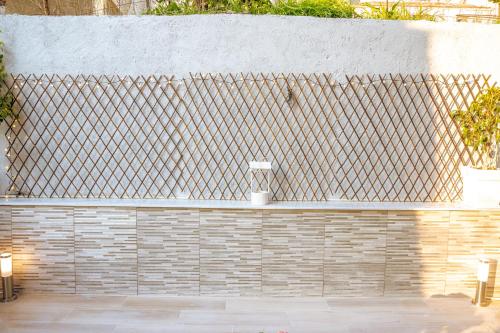 a brick retaining wall with a faucet on it at eliTe deluxe 1 in Kavala