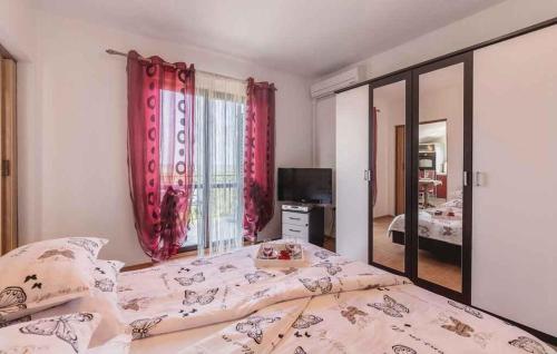 a bedroom with a large bed and a mirror at Apartment in Koromacno - Istrien 33192 in Koromačno
