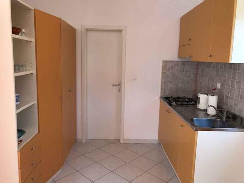 a kitchen with brown cabinets and a counter top at Apartments in Hvar/Insel Hvar 33535 in Hvar