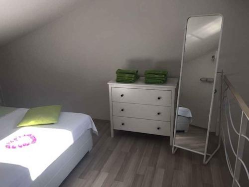 a bedroom with a bed and a dresser with a mirror at Apartments in Hvar/Insel Hvar 33535 in Hvar