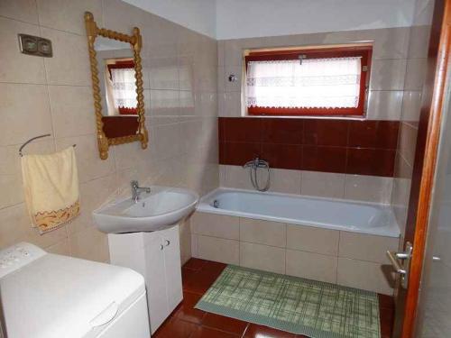 a bathroom with a sink and a tub and a toilet at Holiday home in Balatonfenyves 18431 in Balatonfenyves