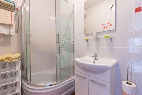 a white bathroom with a sink and a shower at Studio in Vrbnik/Insel Krk 35988 in Vrbnik