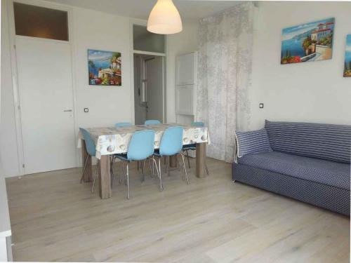 a living room with a table and chairs and a couch at Apartment in Porto Santa Margherita 27854 in Porto Santa Margherita di Caorle