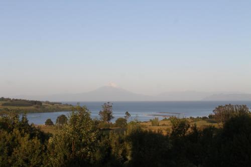 a view of the ocean from a hill at Cabañas Vista Volcanes del Sur in Llanquihue