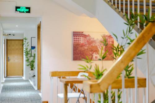 a staircase in a house with plants at Xi'an Travelling with Hotel South Gate in Xi'an