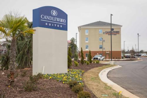 a sign in front of a hotel with a building at Candlewood Suites - McDonough by IHG in McDonough