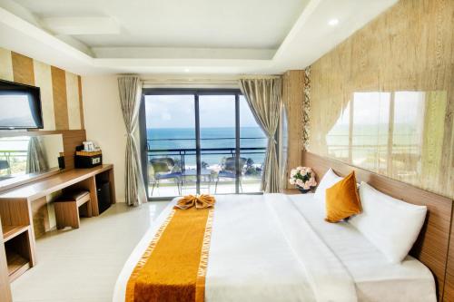 a bedroom with a large bed with a view of the ocean at Oliver Hotel in Nha Trang