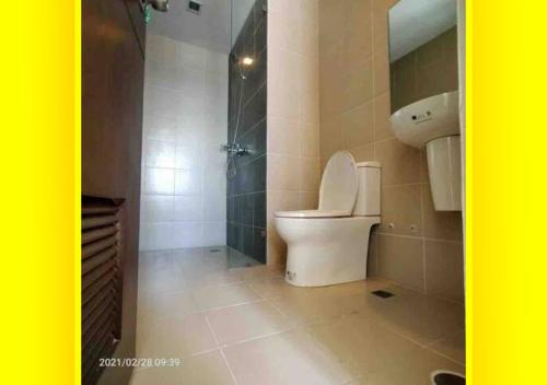a bathroom with a toilet and a sink and a shower at Lafayette Park Square,Iloilo Business Park Condo P in Iloilo City