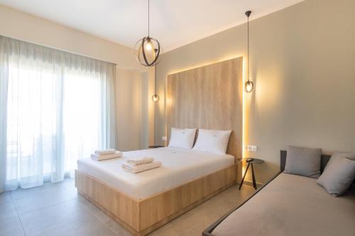 a bedroom with a large bed with towels on it at MEDITERRANEO in Skala Potamias