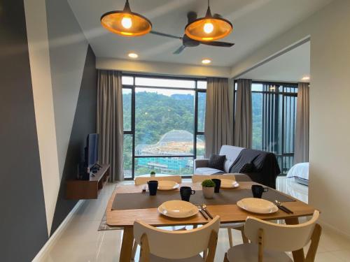 a living room with a table and chairs and a living room at KL East The Ridge in Kuala Lumpur