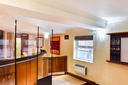 a kitchen with a counter and a window at Tyger Inn Derby in Derby