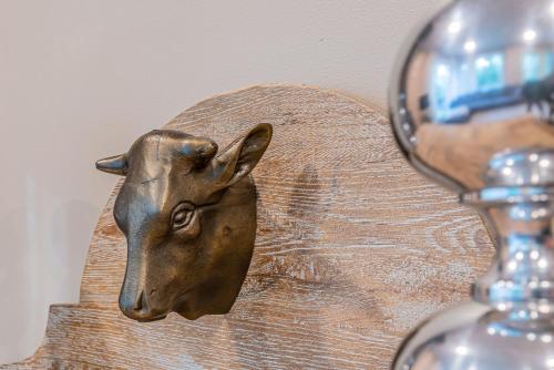 a statue of a deer head next to a wine glass at Saimaa Life Apartments in Imatra