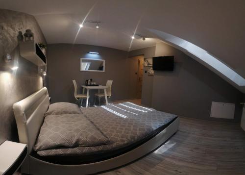 a bedroom with a bed and a night stand at Atmosfera in Rozalin