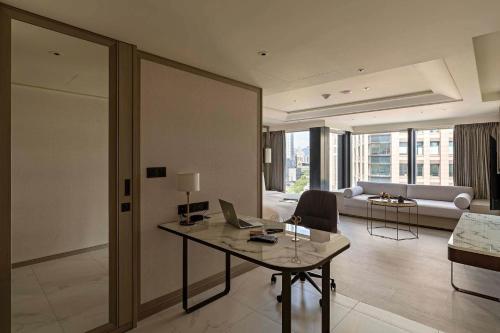 a living room with a desk with a laptop on it at Hanns House in Taipei