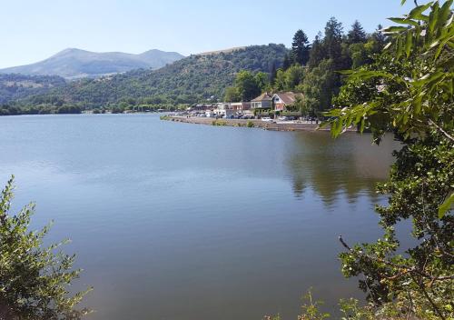 a large body of water with houses on the shore at GÎTE GUERY in Chambon-sur-Lac