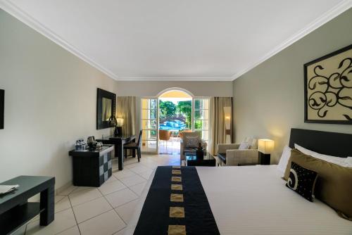 a hotel room with a bed and a living room at The Zuri White Sands, Goa Resort & Casino in Varca