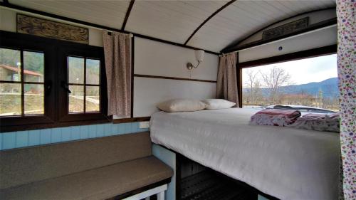 a room with two beds in a train with windows at TORRHEBİA DAĞ EVİ in Odemis