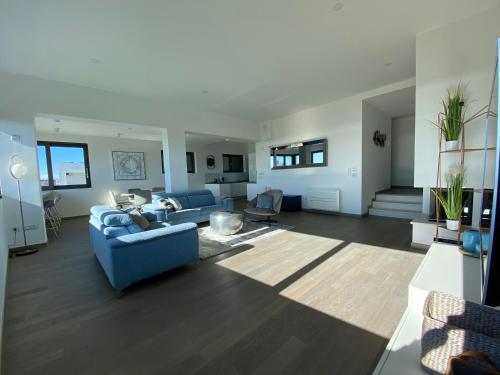a living room with a blue couch and chairs at The View Luxury Residence with Pool in Zadar