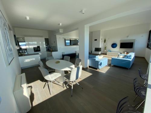 a living room with a table and chairs and a couch at The View Luxury Residence with Pool in Zadar