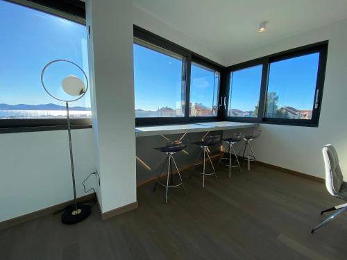 an office with a table and chairs and windows at The View Luxury Residence with Pool in Zadar