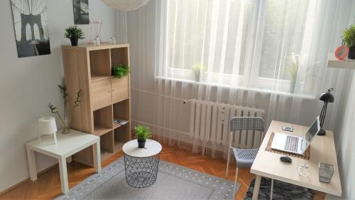 a small room with a desk and a laptop on a table at Apartament Wiosenny 52m2 Kłodzko in Kłodzko