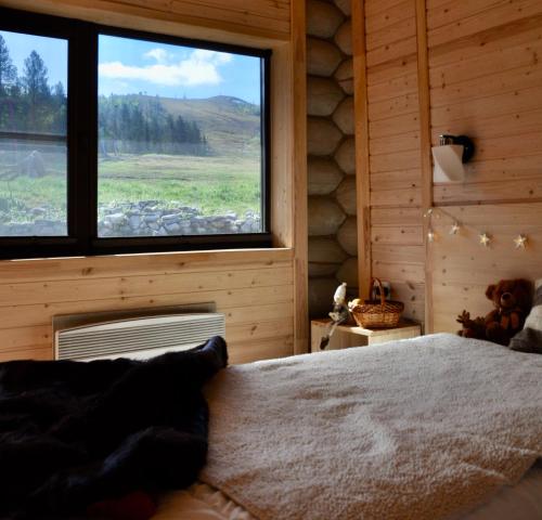 a bedroom with a bed and a large window at Motel Gora Krestovaya in Kandalaksha