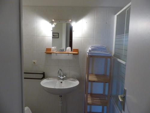 a bathroom with a sink and a mirror at le Chaumois in Saint-Boil