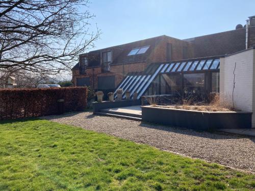 a house with a glass roof and two plants at Rue Haute by M&M 4 sterren bed en breakfast vlakbij Maastricht in Eben-Emael