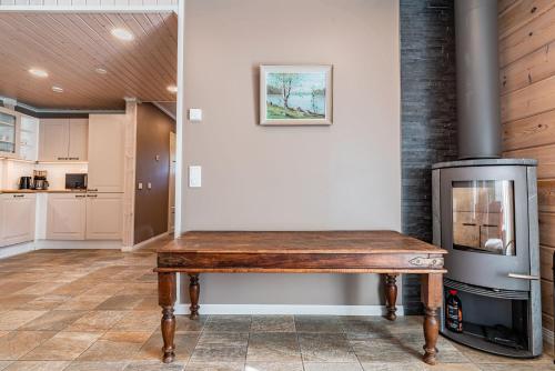 a kitchen with a wooden table next to a stove at Saimaa Life Apartments in Imatra