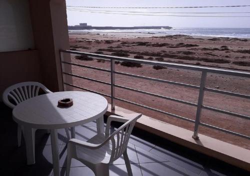 a table and chairs on a balcony with a view of the beach at Sal Rei apartaments, Boa Vista, free WI-FI in Sal Rei