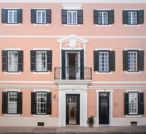 a white building with a blue door and windows at Can Alberti 1740 Boutique Hotel in Mahón
