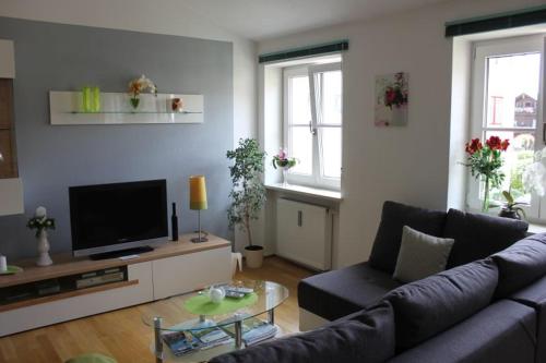 a living room with a couch and a tv at Ferienwohnung Krittian in Teisendorf