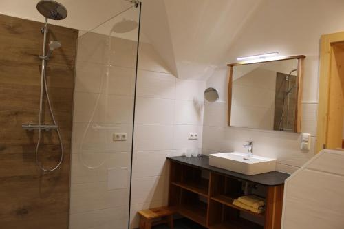 a bathroom with a sink and a shower at Ferienhof Rinnergut in Hinterstoder