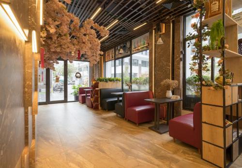 a restaurant with red chairs and a waiting room at BBQ HOSTEL in Ha Long