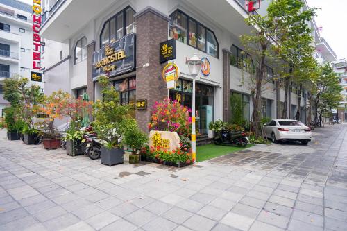 a building with a bunch of plants in front of it at BBQ HOSTEL in Ha Long