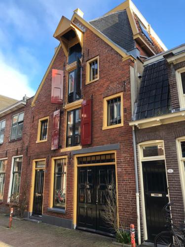a red brick building with black doors and windows at B&B Pakhuis Emden in Groningen