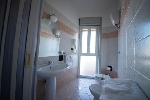 a bathroom with a sink and a toilet at Hotel Venezuela in Montesano sulla Marcellana