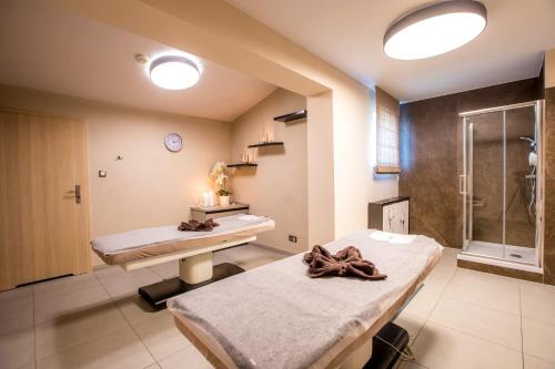 a hospital room with two beds and a shower at Hotel Polanica Resort & Spa in Polanica-Zdrój